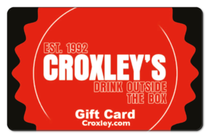 Large Croxleys logo inside an orange illustrated seal with the tagline Drink Outside The Box.